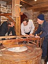 Paul George, Rob Otrum and Roland Tetrault (retired miller from Upper Canada Village) setting up the stones for the first grind.