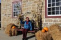 Volunteer Anna Greenhorn enjoys the beautifully decorated front of the Old Stone Mill.  Delta Harvest Festival 2015