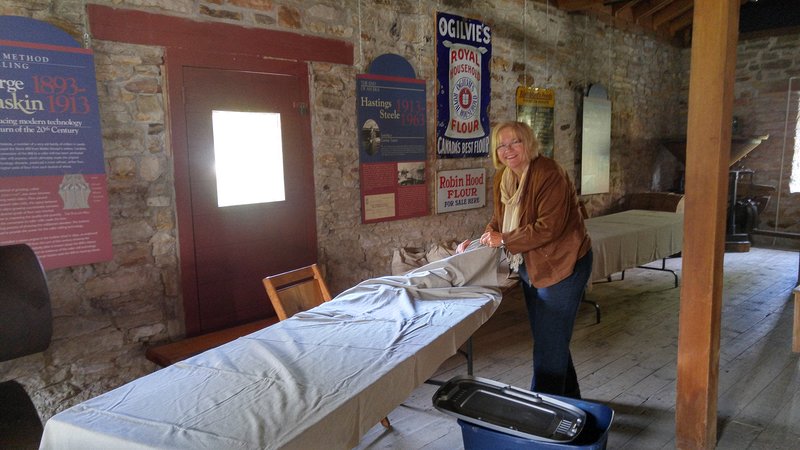 Event Chair Katherine Killins helps set up display tables on the day before the festival.  Delta Harvest Festival 2015