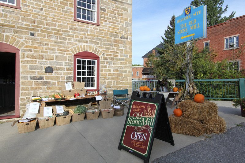 Fall produce is laid out in front of the Old Stone Mill.  Delta Harvest Festival 2015