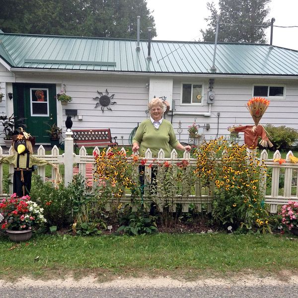 Winner of the best decorated house, Sharon Olivo, amid her colourful Fall flowers and decor. She was pleased to receive a gift certificate for the Green Gecko gift shop in Lyndhurst.